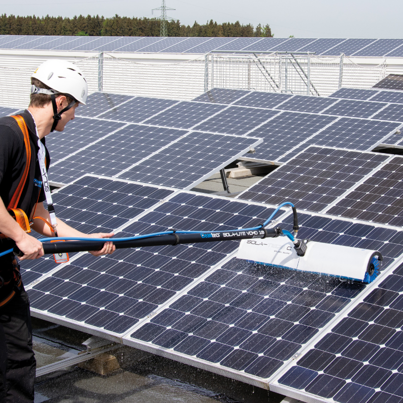 Worker cleaning solar panels with Kranzle equipment
